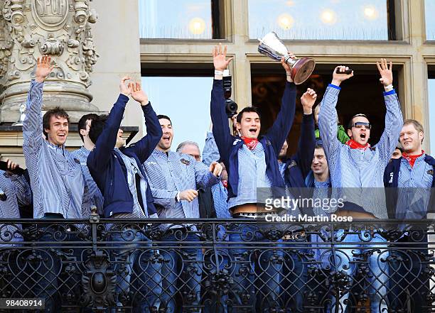 Krysztof Lijewski of Hamburg celebrates with his team mates with the cup at the Hamburg townhall after winning the DHB German Cup final match between...