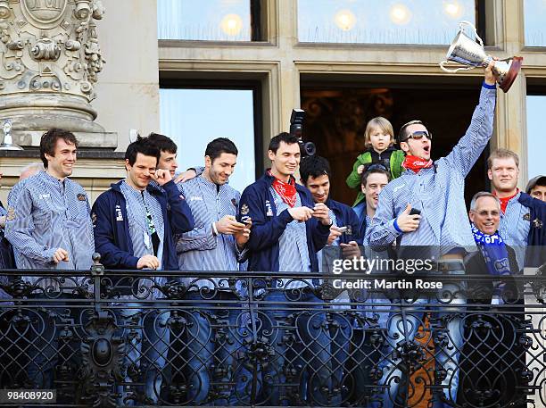 Pascal Hens of Hamburg celebrates with his team mates with the cup at the Hamburg townhall after winning the DHB German Cup final match between HSV...