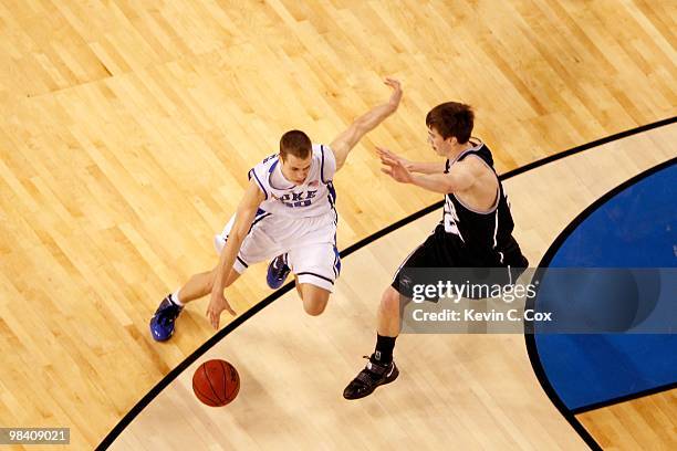 Jon Scheyer of the Duke Blue Devils drives against Gordon Hayward of the Butler Bulldogs during the 2010 NCAA Division I Men's Basketball National...