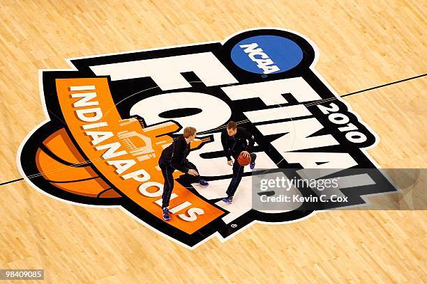 Kyle Singler and Jon Scheyer of the Duke Blue Devils warm up with teammates against the Butler Bulldogs during the 2010 NCAA Division I Men's...