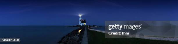 lighthouse paard van marken panorama at blue hour (marken, netherlands) - paard stock pictures, royalty-free photos & images