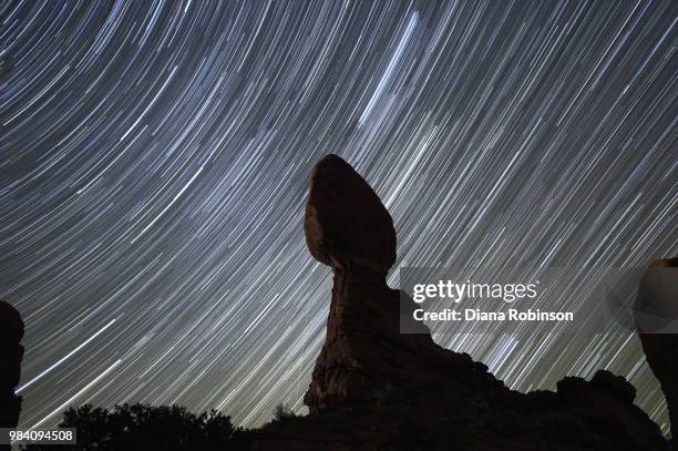 star trails over balanced rock, arches national park, utah - balanced rock arches national park stock pictures, royalty-free photos & images