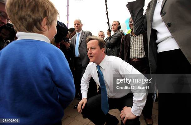 Conservative party leader David Cameron greets a young supporter after delivering a speech to supporters in Loughborough Market Place on April 12,...