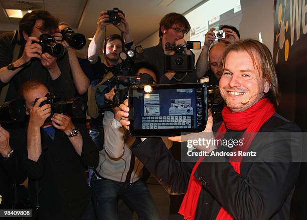 Helmut Hoffer von Ankershoffen, CEO of WeFind AG, holds up a 'WePad' during the launch of the new 'WePad' - a mobile tablet browsing device on April...