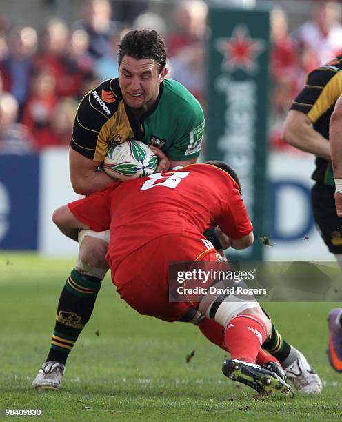 Phil Dowson of Northampton is tackled by James Coughlan during the Heineken Cup quarter final match between Munster and Northampton Saints at Thomond...