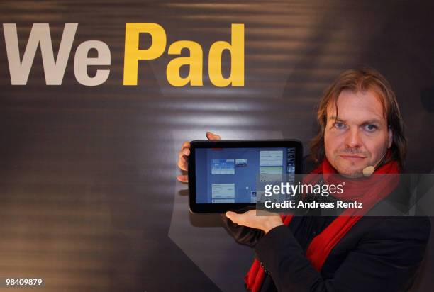 Helmut Hoffer von Ankershoffen, CEO of WeFind AG, holds up a 'WePad' during the launch of the new 'WePad' - a mobile tablet browsing device on April...