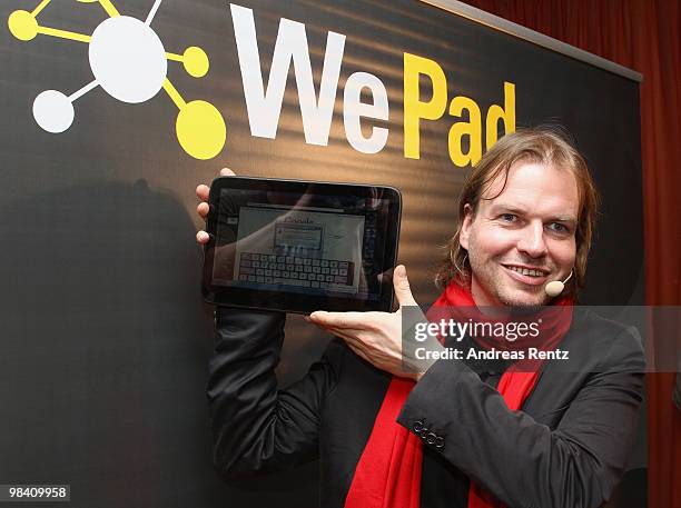 Helmut Hoffer von Ankershoffen, CEO of WeFind AG, holds up a 'WePad' during the launch of the new 'WePad' - a mobile tablet browsing device on April...