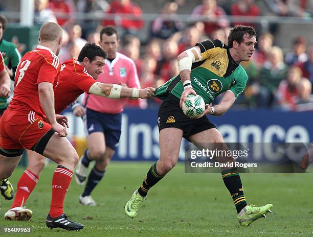 Jon Clarke of Northampton is held by David Wallace during the Heineken Cup quarter final match between Munster and Northampton Saints at Thomond Park...