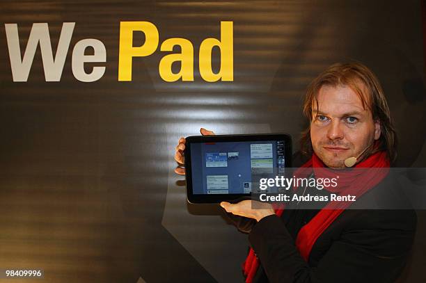 Helmut Hoffer von Ankershoffen, CEO of WeFind AG, holds up a 'WePad' during the launch of the new 'WePad' - a mobile tablet browsing device on April...