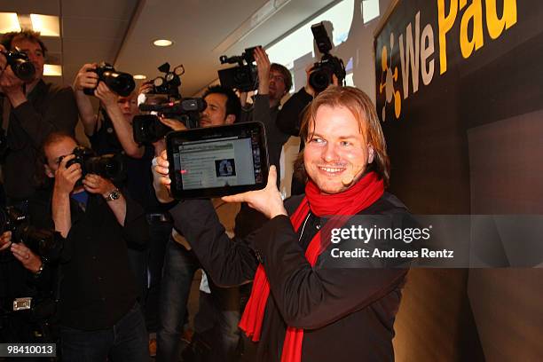 Helmut Hoffer von Ankershoffen, CEO of WeFind AG, holds up a 'WePad' during the launch of the new 'WePad' - a mobile tablet browsing device on April...