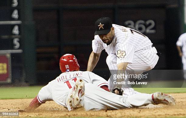 Jimmy Rollins of the Philadelphia Phillies looks up at third base umpire Adrian Johnson after being tagged out by third baseman Pedro Feliz of the...