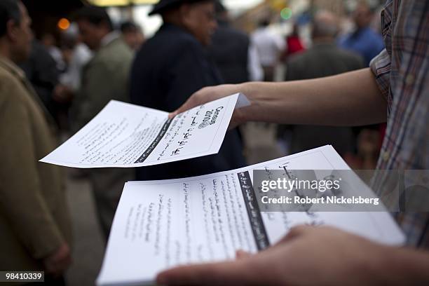 Arab-American men exiting a mosque following Friday prayers take fliers encouraging the arab population to fill out their 2010 census forms April 9,...