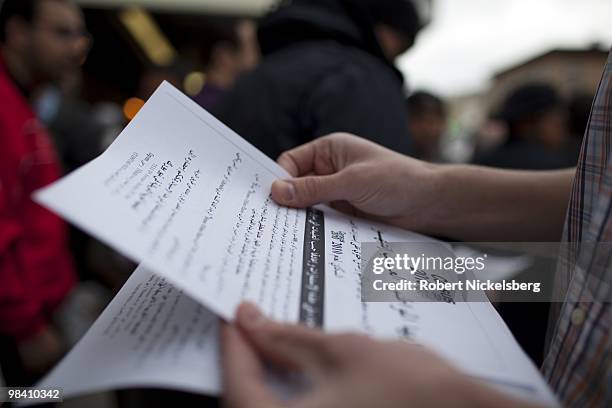 Arab-American men exiting a mosque following Friday prayers take fliers encouraging the arab population to fill out their 2010 census forms April 9,...