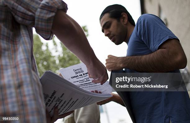 Arab-American men exiting a mosque following Friday prayers take fliers encouraging the arab population to fill out their 2010 census forms April 9,...