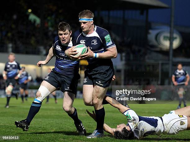 Jamie Heaslip, the Leinster number 8 races away to score his first try despite being held by Morgan Parra during the Heinken Cup quarter final match...