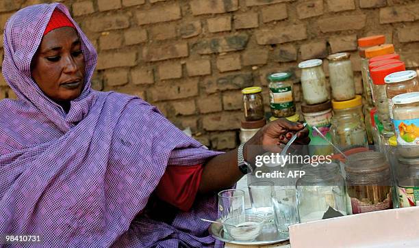 Sudanese street vendor prepares tea for a customer in Khartoum on April 12, 2010. Sudanese nationwide are voting for president as well for...