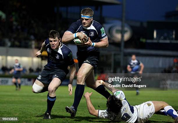 Jamie Heaslip, the Leinster number 8 races away to score his first try despite being held by Morgan Parra during the Heineken Cup quarter final match...