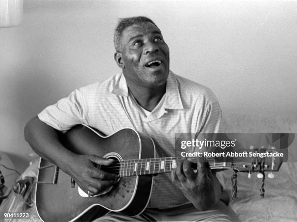 Portrait of blues musician Chester Arthur Burnett better known as Howlin' Wolf, posing with his guitar, during an interview for the Chicago Defender,...