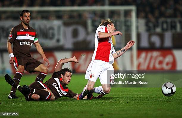 Matthias Lehmann of St. Pauli fouls Michael Thurk of Augsburg during the Second Bundesliga match between FC St. Pauli and FC Augsburg at the...