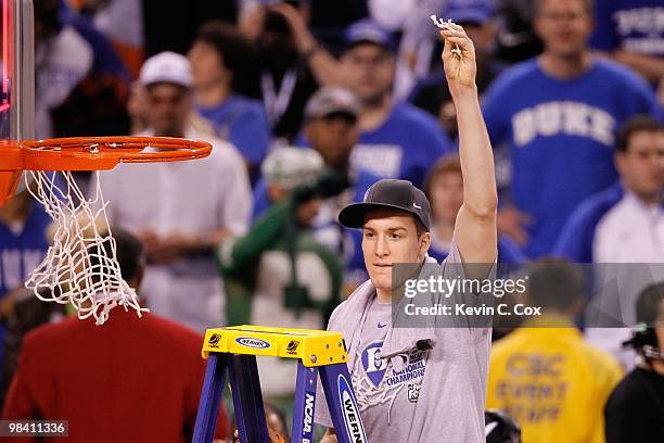 Miles Plumlee of the Duke Blue Devils celebrates after he cut down a piece of the net following their 61-59 win against the Butler Bulldogs during...