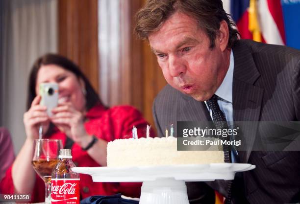 Dennis Quaid blows out the candles on a birthday cake presented to him at a luncheon to discuss the prevention of potentially deadly medical errors...