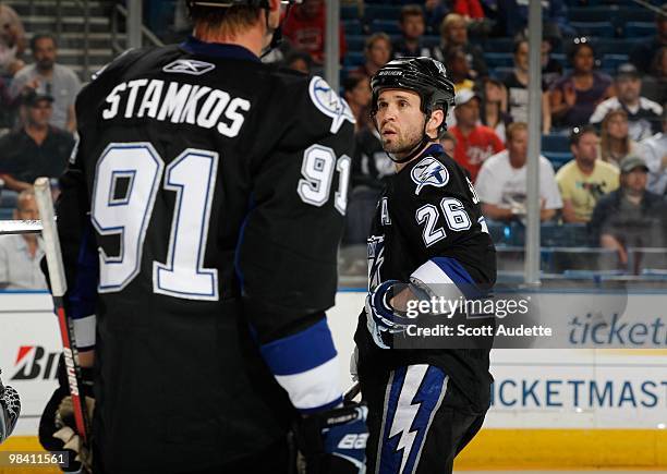 Martin St. Louis of the Tampa Bay Lightning talks with teammate Steven Stamkos during a break in the action against the Carolina Hurricanes at the...