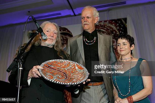 Musician Willie Nelson, social activist/author/filmmaker Turk Pipkin and Christy Pipkin present the Nobelity Project's "Feed The Peace" award to...