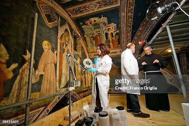 Restorers Sergio Fusetti and Elena Ottaviani work on frescos of the St. Nicola Chapel by Giotto at the Cathedral Basilica of Saint Francis on April...