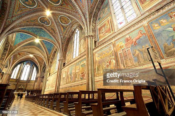 Light illuminates the frescos by Giotto at the Cathedral Basilica of Saint Francis on April 12, 2010 in Assisi, Italy. Small groups of visitors can...