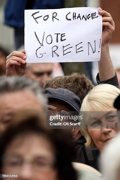 Green Party supporter holds a placard as Conservative party leader David Cameron delivers a speech in Loughborough Market Place on April 12, 2010 in...