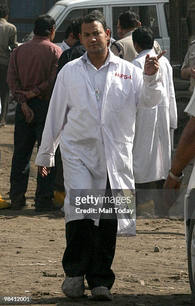 Scientist from the Bhabha Atomic Research Centre oversees the loading of Mayapuri's radioactive scrap in New Delhi on April 9, 2010. 6 people have...