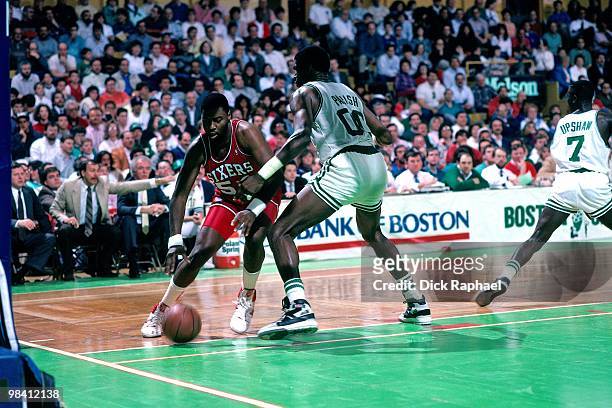 Ben Coleman of the Philadelphia 76ers makes a move to the basket against Robert Parish of the Boston Celtics during a game played in 1989 at the...