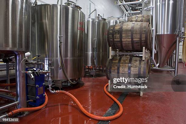 barrels in a brewery - industrial hose stockfoto's en -beelden