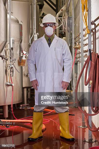 engineer standing in a chemical plant - industrial hose stockfoto's en -beelden