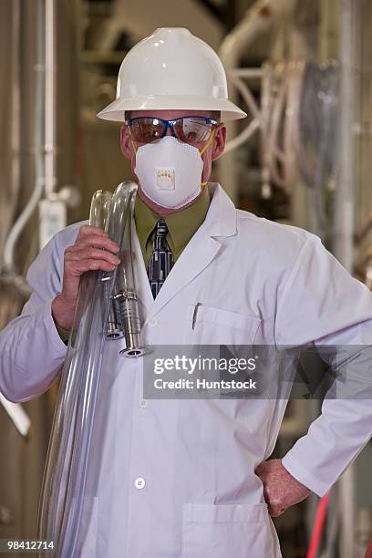 engineer standing in a chemical plant - industrial hose stockfoto's en -beelden