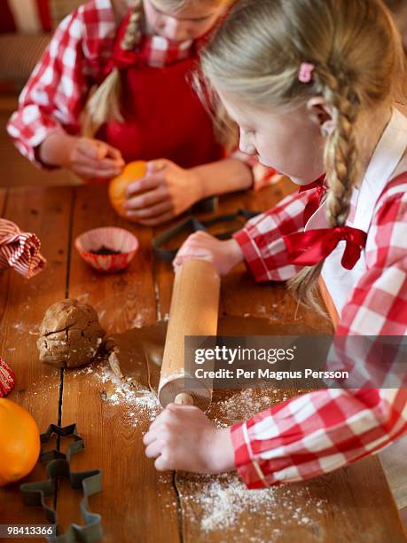 two sisters doing some baking for christmas sweden. - rolling pin stock pictures, royalty-free photos & images