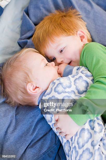 brother hugging his baby sister sweden. - plattform stock pictures, royalty-free photos & images