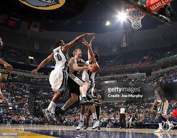 Matt Bonner of the San Antonio Spurs goes up for a shot against Darrell Arthur and Hamed Haddadi of the Memphis Grizzlies during the game at the...
