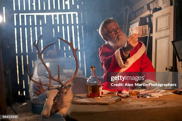 santa claus in a barn with a reindeer sweden. - santa claus lying stock pictures, royalty-free photos & images