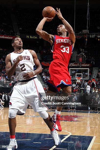 Willie Green of tte Philadelphia 76ers goes up for a shot against Joe Johnson of the Atlanta Hawks during the game at Philips Arena on March 3, 2010...