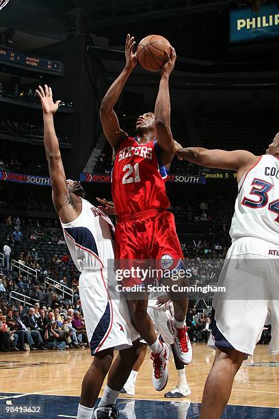 Thaddeus Young of tte Philadelphia 76ers goes up for a shot against Mario West and Jason Collins of the Atlanta Hawks during the game at Philips...