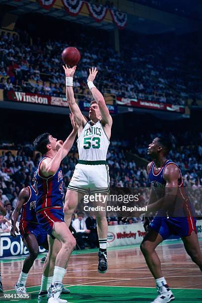 Joe Kleine of the Boston Celtics shoots a jump shot against Bill Laimbeer of the Detroit Pistons during a game played in 1989 at the Boston Garden in...