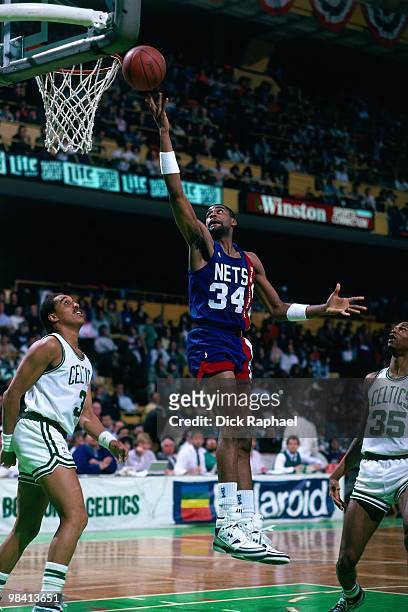 Chris Morris of the New Jersey Nets shoots a layup against Dennis Johnson of the Boston Celtics during a game played in 1989 at the Boston Garden in...