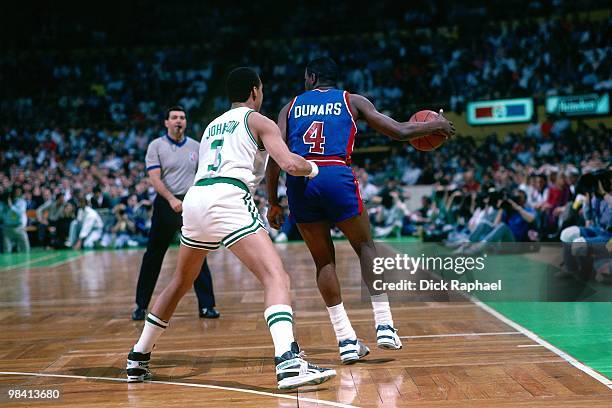 Joe Dumars of the Detroit Pistons looks to make a move against Dennis Johnson of the Boston Celtics during a game played in 1989 at the Boston Garden...