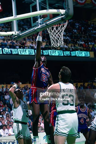 John Salley of the Detroit Pistons shoots a layup against Joe Kleine of the Boston Celtics during a game played in 1989 at the Boston Garden in...