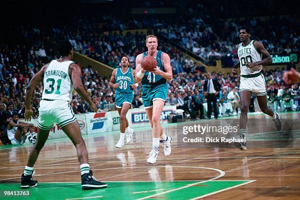 Tim Kempton of the Charlotte Hornets drives the ball up court against Ron Grandison of the Boston Celtics during a game played in 1989 at the Boston...