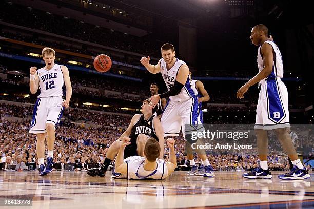 Kyle Singler, Jon Scheyer, Brian Zoubek and Nolan Smith of the Duke Blue Devils celebrate after Scheyer drew a charging foul against Gordon Hayward...