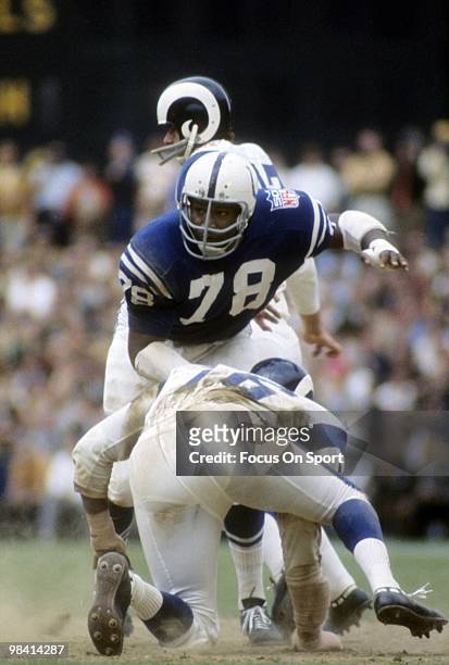 1960s: Defensive Tackle Bubba Smith of the Baltimore Colts pushes to the ground offensive tackle Bob Brown of the Los Angeles Rams circa late 1960's...