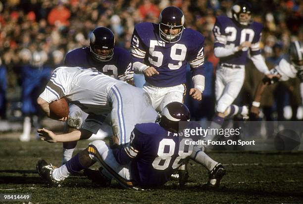 S: Defensive Tackle Alan Page of the Minnesota Vikings pulls down running back Steve Owens of the Detroit Lions circa early 1970's during an NFL...
