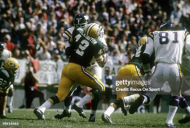 S: Defensive Tackle Alan Page of the Minnesota Vikings hits running back John Brockington of the Green Bay Packers circa mid 1970's during an NFL...